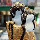 Krispy Kreme Doughnut Soft Serve ice cream cone with chocolate drizzle